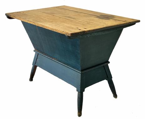 H957 Early 19th Century Pennsylvania Dough Box in beautiful blue paint.  Tightly dovetailed, pegged and square head nail construction with an apron around the bottom that follows the taper of the turned legs. Scrub top is reinforced with a batten attached underneath on each end. Natural patina interior. Circa 1820 � 1830s.  Measurements:  36 ¼� wide x 26 ½� deep x 27� tall