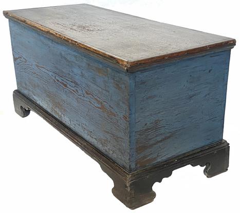 D336 19th century Talbot County, Maryland Blanket Chest with the original blue and black paint, dovetail case and dovetailed feet. The applied bracket base is also dovetailed, it has an oversized glove till with a molded edge lid. One board southern yellow pine construction featuring very unusual, applied molding on the back feet.  Found in a home in Easton, Maryland.  Circa 1800- 1820.  Measurements are 43 1/2" long x 19 1/4" deep x 22" tall
