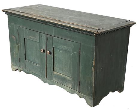 J11 Mid 19th century New England original green painted two door cupboard featuring unusually low height with decorative cut out apron and ends and applied decorative molding around top. Doors are fully mortised and wooden pegged. Clean, natural patina interior. Square head nail construction. 