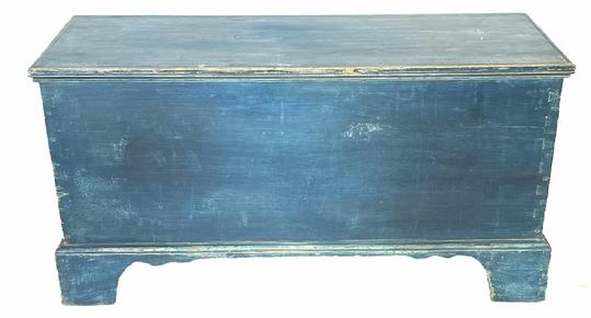 i1 Pennsylvania blanket chest in original blue paint featuring dovetailed case and applied dovetailed bracket base. Applied molded edge around lid. Clean, natural patina interior with a lidded till. Circa 1830s. The wood is white pine. Measurements: 37 ¼� wide x 14 ½� deep x 19� tall