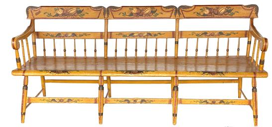 F306 Pennsylvania paint decorated plank-seat Settee of the mid-19th century (1845-65), in the half-spindle-back style with an angel wing crest rail. The mustard yellow is decorated with green leaves, brown fruit and red striping. There is a large fruit in the center, flanked by leaves and various fruit extending out from each side. The theorem-like registers on the crest rails are typical of rural Pennsylvania chairs and benches. The overall result is a pleasing example of Pennsylvania German Folk Art on a piece of rural-made, paint- decorated furniture. Measurements: 79 ¼� wide x 20� deep x 331/2� tall. The seat is 16 ½� tall.