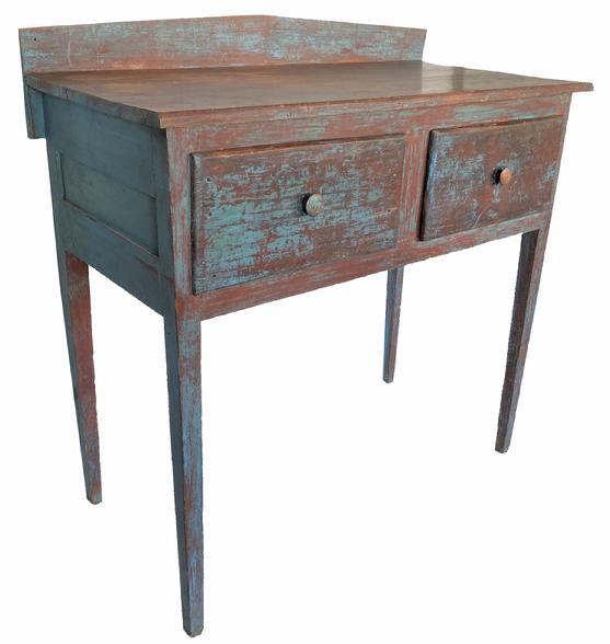 G456 South Carolina  Huntboard,in early blue paint over the original red, with a  applied backsplash, attached tp a one board rectangle top above two large drawers with wooden knobs, paneled ends, the case is resting on tall tapered hepperwhite legs. The wood is poplar and yellow pine, circa 1840 Measurements are 47 3/4" high x 47 1/4" wide x 23 3/4" deep