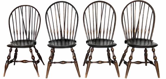 H447 Set of 4 Wallace Nutting Braceback Windsor chairs. Three retain the stamp �301� with partial paper labels, and one retains the stamp �303� with full paper label and �WALLACE NUTTING� stamp below the label. Each chair retains its original light brown finish.  In the early 20th Century Wallace Nutting (1861-1941) was the most famous builder of Windsor chair reproductions.