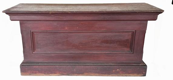 J277  19th century New England  6' store Counter, in original red  paint , from a  Country store in Maine . with one single panel in the front, and ends, two board top. It has a nice applied  molding, all square nail construction. The back is open to reveal a single shelf for storage,   Measurements:  72� wide x 27 ½� deep x 33 3/8� tall