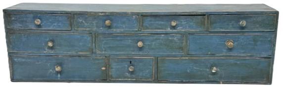 **SOLD** M171 Early 19th century Pennsylvania blue painted Apothecary with an unusual layout of ten drawers with cock beaded fronts and brass knobs. One drawer has a divided interior. Dovetailed case and drawers with a combination of T nail and square head nail construction throughout. The woods are walnut and white pine. Circa 1800-1810. Faint, illegible names / writing on bottom of one of the drawers appears to show a succession of how this chest was passed through a family and indicates various dates including 1813, 1862 and 1900. Measurements: 36 wide x 8 deep x 10 tall.