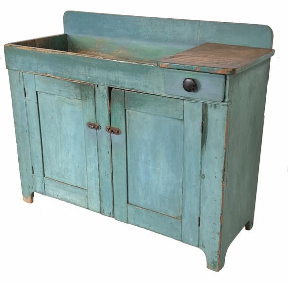 H137 Mid 19th century Pennsylvania Drysink, in original blue paint, circa 1850-1860  with a single drawer under a small work area. Two panel doors open to the interior with two shelves in beautiful old natural patina. Measurements are: 18 1/4" deep x 43 1/2 long x 36" tall