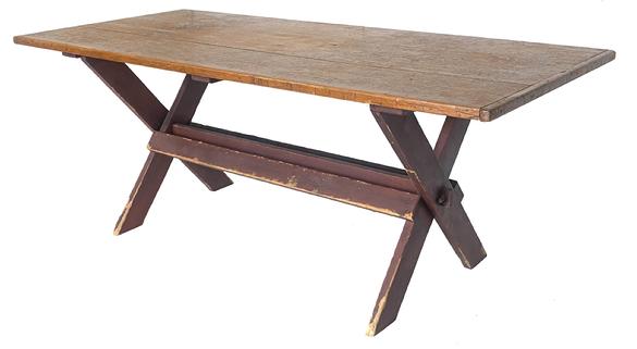 Red painted sawbuck table featuring a classic design with �X� base supported with cross stretchers and a three-board top with breadboard ends. Great patina and wear indicative of age and years of use. Measurements: 72¼� long x 32� deep x 28¼� tall