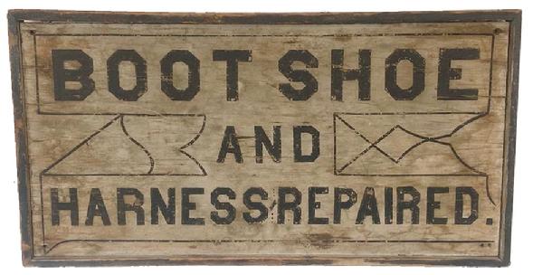 H297 Mid-19th century Pennsylvania double-sided wooden trade sign advertising "Boot(s) Shoe(s) And Harness(es) Repaired". Each side boasts a different layout of the slightly differing wording. The lettering on both sides is done in black paint on a white background. A black painted molding, secured with square head nails, surrounds the entirety of the sign. Measurements: 38" wide x 19 3/4" tall x 2" thick