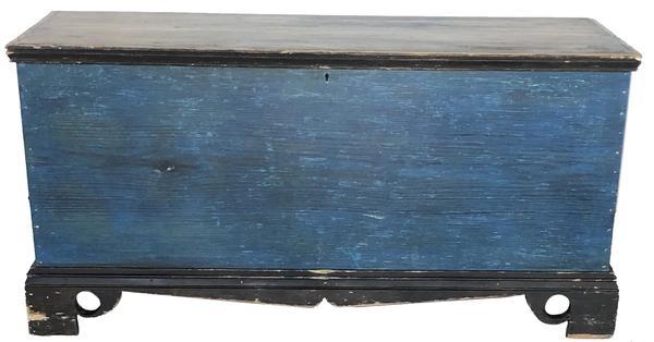 E439 Early 19th century Sussex County, Delaware Blanket Chest retaining its original paint. Blue case with applied black painted bracket base, with typical Delaware cut out feet. Six board yellow pine square head nail construction. Nice clean interior with a locking glove til. Circa 1830. Measurements: 43" wide x 21" tall x 16" deep.