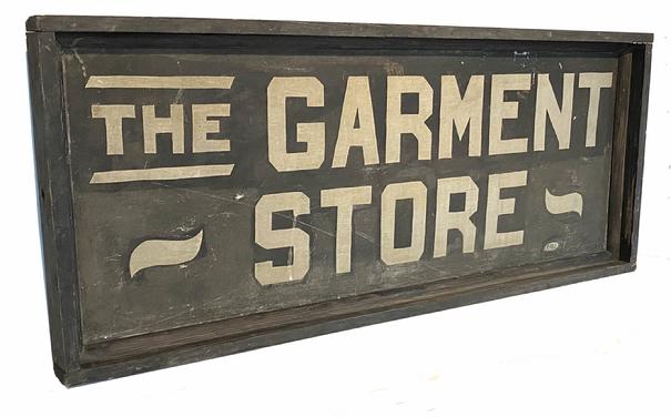 **SOLD** G873 Late 19th century American Folk Art painted wood and tin double-sided Trade Sign, featuring white lettering against a black background that reads: "THE GARMENT STORE".  Signed by the artist, �PEARCE�, in the lower right corner of each side. Rectangular metal sign with applied wooden molded frame  Measurements:  48" wide x 2 1/2� thick x 20� tall