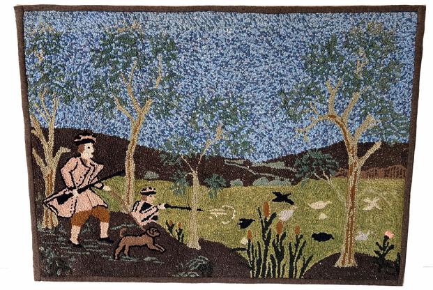 H176 HOOKED RUG, rectangular form, depicting two hunters with a dog, the hunter in the back shooting his rifle at a flock of birds. Trees and cattails line the scene, mountains and blue sky in the background. Very tightly hooked wool on burlap, with wool binding applied to edges. Mounted to fabric on a wooden stretcher for hanging. Second quarter/mid 20th century. Rug measures 36" x 26".