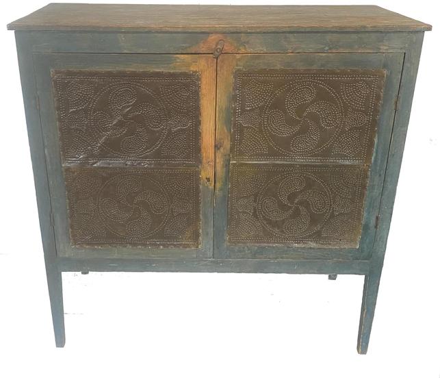 G875 GORGEOUS EARLY 19TH CENTURY SHENANDOAH VALLEY OF VIRGINIA FOOD SAFE wide rectangular top above two doors concealing two shelves with a lower divider, the Food Safe is raised on square-legs. Each door and end set with two oversized joined tins hand punched with a central fylfot surrounded by fans.  original blue-painted surface. Found in eastern Rockingham Co., VA. Second quarter 19th century. Measurements are 53 ½ � high x 53 wide x 23 deep 