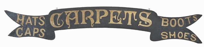 J296 Superb mid-19th century banner / ribbon, shaped Trade Sign advertising �Carpets� in the center � with �Hats� and �Caps� on the left, and �Boots� and �Shoes� on the right. Fantastic original painted surface consisting of gold gild hand painted letters on a black painted background. Circa 1850-1860s.