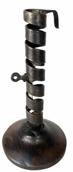 RM1406 18th century Spiral Iron Courting Candlestick with stamped maker's mark "VA & LM". Wooden base. Measurements: 7 1/5" tall x 3 7/8" diameter base