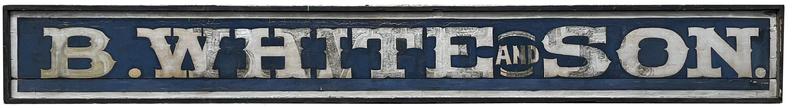 J137 Very early long wooden trade sign from eastern Pennsylvania � advertising �B. WHITE and SON.� Letters are painted in silver on a dark blue background. Sign boasts molded edge on all sides.  A separate framed photograph goes along with this sign � showing it as it was hung on the original storefront � and history reveals itself when viewing the reverse side of the sign as it bears the original �B. WHITE� sign as photographed and indicates the sign was added on to as the family grew to �B. WHITE and SON.� Sign measures 126 ½� long x 16� tall x 2 ¾� deep. Framed photograph measures: 16� wide x 14� tall x 1� thick