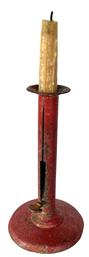 **SOLD** J63C Early 19th century iron hogscraper push up candlestick in old red painted surface. Retains original tight, working push-up thumb tab. Unmarked. Surface pitting and wear indicative of age and use. Very sturdy and tight. Measurements: 7 tall with 4 diameter base.   