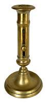 M142 19th century solid Brass Push Up Candlestick. Nice, heavy weight and the push-up feature is fully functional. Measurements: 4 1/8� bottom diameter x 8� tall.  