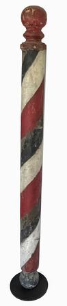 **SALE PENDING** K1762 Wonderful late 19th century solid wood turned Barber Pole bearing a multi-layered painted and weathered red, white and blue painted surface with areas of the original paint showing through. Pole rests on a cast iron base for display purposes.  A nice, solid wooden ball turning on both top and bottom adds to the visual appeal of this pole!  From a New Jersey collection. Measures: ~5 diameter x 64 tall. The metal base measures 10 diameter. 